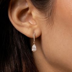 Simply elegant, and absolutely gorgeous. Welcome these timeless diamond dangle earrings into your life! We make our pear cut diamond drop, diamond huggie hoop earrings in your choice of 18k gold (rose, yellow, or black, or white upon request). Here, in 18k rose gold. 18k rose gold pear cut diamond drop earring on diamond-faced hinged huggie hoops. 2.12cts (pair) of white diamonds. F color, VS1 clarity 18k rose gold hardware. Diamond-faced hinged huggie hoop earwires with hidden closure. Lovingly Luxury Diamond Cut Drop Huggie Earrings, Luxury Dazzling Huggie Earrings With Diamond Accents, Luxury Formal Huggie Earrings, Luxury Teardrop Diamond Earrings With Brilliant Cut, Elegant Luxury Huggie Earrings With Prong Setting, Luxury Dangle Huggie Earrings With Prong Setting, Luxury Dainty Huggie Earrings With Diamond Accents, Timeless Luxury Huggie Earrings For Anniversary, Luxury Diamond Drop Earrings With Pave Setting