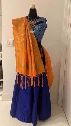 Blue chanya choli with orange dupatta. Blue chanya(skirt) has made up of Tafeta silk. Brocade Blouse with unique pattern of blue and golden threads comes with extra sleeves. Orange dupatta with golden zari threads. Item Contain : Blue and orange chanya choli set Chanya(skirt) Length : 42 Inches Blouse Length : 14.5 Inches Sleeves : Sleeveless (But it has extra sleeves of length 5 Inches) Item In Box: 3 pc outfit Color : Blue ( As Shown In Image ) Fit Type : Regular Fit Occasion: Will add luster when worn for a wedding, engagement, party, prom, navratri(garba) and any special occasion. It will enhance special days like Valentine's Day, Birthdays, Anniversaries and Mother's Day Gift. Color Declaration: There Might Be Slight Variation In The Actual Color Of The Product Due To Different Screen Orange Dupatta, Sangeet Ceremony, Navratri Garba, Navratri Chaniya Choli, Brocade Blouse, Brocade Blouses, Chaniya Choli, Silk Brocade, Blue And Orange