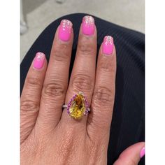 This gorgeous ring has a magnificent Pear Cut Citrine Quartz weighing 5.28 Carats and is surrounded by 25 Pink and Yellow Sapphires that weigh 0.60 carats and 20 Round Cut Diamonds that weigh 0.37 carats. (Clarity: SI, Color: F) The total carat weight of the ring is 6.25 carats. Each stone is handpicked and carefully curated to create a unique piece by our in-house designer and jeweler! The Citrine measures approximately at 11 mm x 16 mm. It is set in 14K White Gold and weighs approximately 3.8 Luxury Multi-stone Yellow Gemstones, Luxury Yellow Pear-shaped Ring, Luxury Yellow Multi-stone Gemstones, Elegant Yellow Pear-shaped Diamond Ring, Dazzling Oval Yellow Ring, Yellow Multi-stone Sapphire Ring, Dazzling Yellow Oval Ring, Elegant Yellow Sapphire Topaz Ring With Accent Stones, Elegant Yellow Sapphire Ring For Wedding