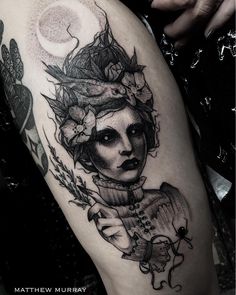 a woman's leg with a tattoo on it and a moon above her head