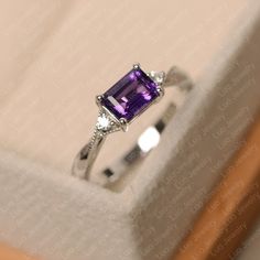 Classic Emerald Cut Solitaire Amethyst Ring, Classic White Gold Emerald Cut Amethyst Ring, Emerald-cut Amethyst Birthstone Promise Ring, Emerald Cut Amethyst Birthstone Promise Ring, Elegant Emerald Cut Amethyst Birthstone Ring, Elegant Emerald-cut Amethyst Birthstone Ring, Classic Sterling Silver Amethyst Ring With Emerald Cut, Emerald Cut Amethyst Ring For Formal Occasions, Classic Emerald Cut Amethyst Ring In Sterling Silver