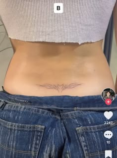 a woman's stomach with the bottom half covered in tattoos on her belly and two hearts