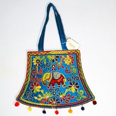 This Is A Lovely, Bright Embroidered Shoulder/Handbag From India. It Is Very Colorful With A Base Of Blue And Needle Work Of Green, Red Purple, Yellow, Magenta, Orange And Silver Threading Holding And Connecting The Flowers And Swirls Together And Surrounding A Lucky Elephant. There Are Also Tiny Mirrors To Reflect The Light. The Back Is Solid Blue Silk (No Embellishment). The Inside Has One Small Zippered Pocket In A Large Compartment And Is Fully Lined In A Matching Light Cotton. The Bag Zips Embroidery Shoulder, Orange And Silver, Frye Bags, Indian Blue, Lucky Elephant, Tan Bag, Tapestry Bag, Printed Purse, Quilted Handbags