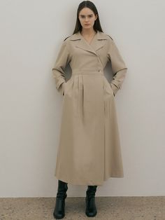 Editor's NoteTrench layered design with a classic and feminine mood. It is possible to adjust S/M size with the fabric belt and skirt waist adjustment button.- Sleeve bijou and shoulder epaulet detail- Use inner buttons on the front skirt to prevent opening during activities.- Point with asymmetric tuck detail on the front of the skirtMeasurements (inch)ONE SIZE (XS-M)- Shoulder: 18.50 in.- Chest: 17.32 in.- Waist: 14.17 in.~15.35 in.(control button +-)- Hem: 25.59 in.- Sleeve: 21.65 in.- Sleeve Opening: - Length: 50.79 in.*One size that can be worn KR44~ 66 by actual measurement*Model Size: Height 5'68, Bust 31, Waist: 23, Hips 35*By measuring the section, an error of 0.4-0.8 inch may occur depending on the measurement location.Composition & Care- 78% Polyester, 18% Rayon, 4% Span- Th Chic Beige Dresses With Belted Cuffs, Classic Belted Dress For Workwear, Elegant Beige Belted Outerwear, Beige Fall Dress With Belted Cuffs, Fall Beige Dress With Belted Cuffs, Classic A-line Belted Dress, Elegant Belted Neutral Outerwear, Elegant Khaki Outerwear With Belted Cuffs, Beige Classic Midi Dress For Daywear