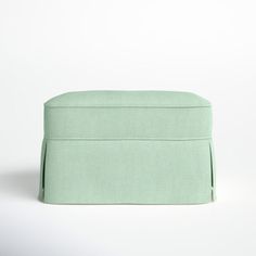 a light green ottoman cover on a white background with the bottom section folded up to show it's back end