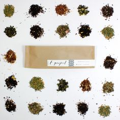 a bag filled with lots of different types of herbs on top of a white table