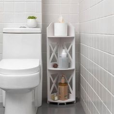 a white toilet sitting in a bathroom next to a shelf filled with soap and lotion