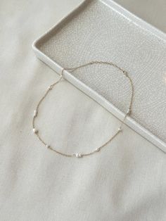 This delicate mixed Pearl chain necklace is minimal yet unique and puts a modern twist on a classic Pearl necklace! The genuine white Pearls are unevenly distributed on the sparkly dainty chain. This is a beautiful piece that is sure to get you many compliments! * 14K Gold Filled or 925 Sterling Silver chain & dainty spring clasp * Choose from 16"-18" or 18"-20" length * 3mm-5mm Freshwater Pearls * 14/20 gf or 925 stamp for authenticity * Made with 100% hypoallergenic materials See all Pearl Jew Minimalist White Chain Necklace For Everyday, White Minimalist Single Strand Chain Necklace, Minimalist White Chain Necklace With Delicate Chain, Minimalist White Single Strand Chain Necklace, Delicate White Chain Necklace For Everyday, Minimalist White Delicate Chain Necklace, Delicate Everyday Necklaces, Everyday Delicate Pearl Chain Necklace, White Minimalist Necklace With Delicate Chain