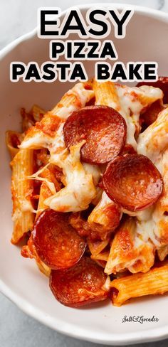 easy pizza pasta bake in a white bowl on a marble counter top with text overlay