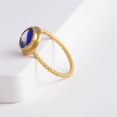 Description One-of-kind 18k yellow gold ring with a unique bi-color oval sapphire with darker and light blue hues, set in an east-west setting. The color of this sapphire is like seeing where the sky and the ocean meets at the horizon. This ring is in a rope design, adding a little more detail to every part of the ring. Details 18k Yellow Gold Size of sapphire – 7.1 x 6.1 x 2.8 mm (1.17 ct) Made in Japan *Please note that due to the natural quality of the stones, there may be inclusions, cracks, Fine Jewelry Sapphire Cabochon Ring, Fine Jewelry Sapphire Ring With Cabochon Cut, Fine Jewelry Blue Cabochon Sapphire Ring, Blue Cabochon Sapphire Ring In Fine Jewelry Style, Fine Jewelry 14k Gold Sapphire Ring With Oval Cabochon, Blue Cabochon Sapphire Ring In 14k Gold, Sapphire Bezel-set Oval Cabochon Ring, Oval Cabochon Sapphire Ring With Bezel Setting, Blue Oval Cabochon Sapphire Ring