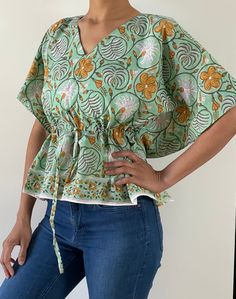 Blouses are made of Indian hand block cotton fabric in beautiful prints. Total 6 prints available, choose your option from drop down menu!  It is made to fit few sizes of 2 to 12 easily, please check measurements!  Great for work/outings/vacations.  Length - 21.5" Bust - fits up to 43" of bust all around.  Waist - fits up to 37" of waist all around. My bust is 36" and waist is 28" for reference. Caftan blouse has drawstring waist for a cinched waist look. You can adjust accordingly!! If you like Green Printed V-neck Top, Hand Printed Relaxed Fit Tops For Summer, Hand Printed Relaxed Fit Summer Tops, Bohemian Cotton V-neck Top, Summer Block Print Short Sleeve Top, Summer Short Sleeve Top With Block Print, Pattern Print Cotton Short Sleeve Top, Cotton Short Sleeve Top With Pattern Prints, Cotton Top With Pattern Prints And Short Sleeves