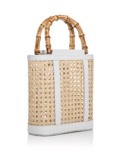 Discover the elegant Emerald Open Weave Rattan Mini Tote by Lusana. This stylish bag features an open top design with faux bamboo wood-tone handles and leather trim accents. Crafted from rattan and leather, this lightweight and versatile bag is perfect for any occasion. Double handles with a 4" drop 9"W x 3"D x 8.5"H Imported White Leather Shoulder Bag With Bamboo Handle, White Rectangular Woven Leather Straw Bag, Leather Bucket Bag With Bamboo Handle In Natural Color, Natural Leather Bucket Bag With Bamboo Handle, White Rectangular Straw Bag With Bamboo Handle, Modern Summer Bags With Bamboo Handle, White Woven Leather Straw Bag, Spring Rattan Bags With Bamboo Handle, White Straw Bag With Bamboo Handle