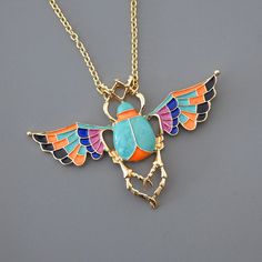 "Vintage Jewelry - Scarab Necklace - Gold Necklace - Vintage Inspired Necklace - Turquoise Necklace - Colorful Necklace - Scarab Jewelry This is such an awesome necklace! Beautiful colors.  A gorgeous large scarab beetle bug is embellished with colorful enamel of turquoise, orange,black and purple.  The pendant hangs from a gold plated chain. Chloe says, Wear it and feel fabulous!\" The pendant is  2\" tall and 3\" wide.  You can choose the length you would like at checkout. Thanks for visiting Colorful Pendant Jewelry As A Gift, Colorful Necklace With Adjustable Chain As Gift, Colorful Metal Necklace As A Gift, Colorful Metal Necklaces For Gifts, Colorful Metal Necklaces As Gift, Colorful Metal Jewelry For Gifts, Colorful Metal Jewelry As A Gift, Colorful Metal Jewelry As Gift, Colorful Metal Jewelry Gift