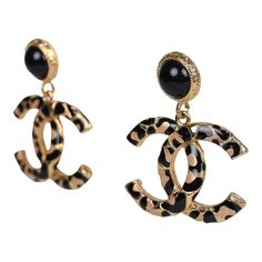 These Chanel large leopard print CC dangle earrings are in black and brown enamel with gold tone hardware, featuring CC enamel printed earrings dangling from black enamel button earrings with post back closures.Origin: FranceCondition: New and never wornAccompanied by: Chanel jewelry boxMeasurements: 1.6" height x 1" width Printed Earrings, Earrings Dangling, Black Earrings Dangle, French Fashion Designers, Chanel Accessories, Chanel Earrings, Chanel Jewelry, Button Earrings, Ear Rings