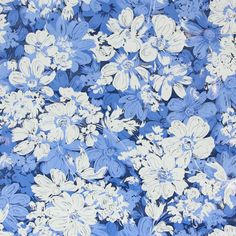 a blue and white floral print fabric with large flowers on the bottom half of it