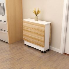 a small wooden cabinet next to a white stove and microwave in a room with hard wood flooring