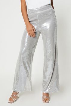 Introducing our stunning Sophie Habboo Sequin Wide Leg trousers. Designed for the fashion-forward woman, these trousers feature a beautiful silver sequin finish that adds a touch of glamour to any outfit. Made with high-quality materials, they are comfortable to wear and perfect for special occasions or a night out. Pair them with a white top for a chic and stylish look that will make heads turn. Get ready to strike a pose and capture the perfect photo in these fabulous trousers. Silver Outfit, Sequin Flare Pants, Holiday Fits, Outside Play, Ideas For Sewing, Jumpsuit Elegant, Womens Designer Fashion, Clothes Horse, Silver Sequin