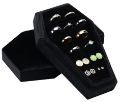 six pairs of rings in a black velvet box