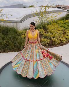 A multi-colored brocade mosaic scalloped lehenga paired with a yellow silk blouse and a pink tulle dupattaFrom Liz Paul’s Signature collection DELIVERY TIMEPlease allow 8-12 weeks for your outfit to arrive. FABRIC DETAILSRaw silk. Professional cleaning only. Liz Paul Lehenga, Fusion Style Multicolor Sets For Navratri, Multicolor Fusion Sets For Navratri, Multicolor Navratri Sets, Fusion Style Multicolor Sets With Traditional Drape, Yellow Organza Sets With Mirror Work, Fusion Multicolor Designer Wear Sets, Fusion Style Multicolor Sets With Cutdana, Fusion Multicolor Sets With Cutdana