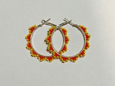 Small hand beaded hoops. With yellow and orange seed beads. Indigenous made Orange Small Hoop Summer Jewelry, Orange Small Hoop Jewelry For Summer, Summer Orange Hoop Jewelry, Summer Small Hoop Orange Jewelry, Summer Orange Small Hoop Jewelry, Handmade Adjustable Yellow Hoop Earrings, Bohemian Yellow Hoop Earrings, Yellow Tiny Beads Earrings For Festival, Yellow Tiny Beaded Earrings For Festival