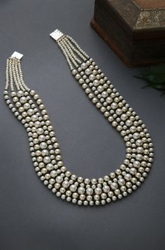 Black-White Gold Tone Beaded Necklace.Elegant and modern,White beaded necklace will complete your lavish ensemble grandeur. Necklace Size - 24 inches. Closure - Adjustable Style Tip - We love teaming this with classy chiffon sarees or zari silk sarees. Also looks best when worn with your royal whites, off whites and gold. We recommend styling with pastel solids or floral dresses in peachy pink, pistachio green and pastel blue too. Handcrafted in Jammu and Kashmir Paisley Pop travels the depths o White Pearl Chain Beaded Necklaces Temple Jewelry, White Round Beads Pearl Necklace In Temple Style, White Round Beads Pearl Temple Necklace, White Pearl Beaded Temple Necklace, Elegant Multi-strand Festive Beads, Elegant Bridal Necklace With Large Round Beads, Festive White Pearl Necklace With Polished Beads, Temple Style Pearl Beaded Necklaces, Beaded Pearl Temple Jewelry Necklace