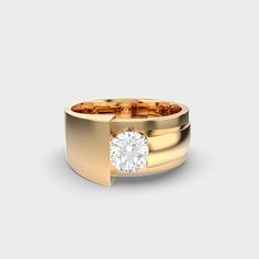 a gold ring with a white diamond in the center