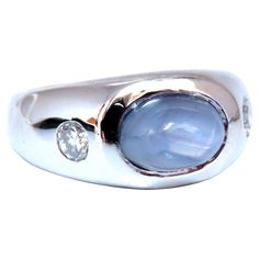 Raised halo sugarloaf. 6ct Natural Cabochon cut sapphire ring. Gray Blue color / Transluscent 9x6mm .40ct Natural Side round diamonds. G-color Si-1 clarity. 14kt. white gold 12.6 grams Ring Current size: 7.5 depth of ring: 9mm (Free Resize Service, Please inquire) $5000 Appraisal Certificate to accompany. Luxury Silver Diamond Ring With Cabochon, Jewlery Aesthetic, Y2k Tech, Marble Rings, Unusual Engagement Rings, Blue Sapphire Ring, Dope Jewelry, Cabochon Ring, Jewelry Studio