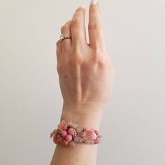 "This is a vintage post-WW2 West Germany bracelet. The back of the center cluster is a gold tone metal with the West Germany signature. The front of the bracelet is a variety of pink tone beading. The beads even include a leaf shape for texture and variety. The band of the bracelet is a wrap/coil style and is made of the same pink tone beads in the center cluster. The bracelet is in great condition. Measurements: Length: 6\" | Width: 1.5\" Unless otherwise stated all vintage items are used and m Vintage Pink Bracelets For Wedding, Vintage Pink Wedding Bracelets, Unique Adjustable Pink Cuff Bracelet, Vintage Pink Wedding Bracelet, Pink Jubilee Bracelet For Party, Handmade Vintage Pink Jewelry, Handmade Pink Cuff Bracelet For Wedding, Vintage Pink Beaded Bracelet, Unique Pink Bangle Bracelets