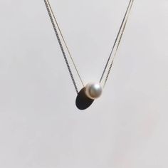 A beautiful, dainty floating pearl necklace made of 9ct yellow gold. The pearl is a genuine cultured freshwater pearl. It is 8mm in diameter and has been hand drilled to float on a 0.75mm delicate 9ct gold chain. Chain length can be chosen from the drop box at checkout. Pearl is the birthstone for June and so this stunning necklace would make the perfect gift for a June baby. Pearl also represents the 30th anniversary of a special bond and can be given as an anniversary present to signify the be Floating Pearl Necklace, Gold Minimalist Jewelry, Drop Box, Tiny Diamond, Gold Ring Stack, Freshwater Pearl Necklace, Gold Diamond Earrings, June Birthstone, Solid Gold Jewelry