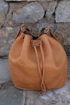 "Handmade Real Leather Bucket Bag in natural biege color Dimensions the bags: Height: 30.0cm (11.8\") Base: 29.0 x 17.0cm (11.4\" x 6.7\") Max. Strap Length: 127.0cm (50\") All Bags are made to order. If you like this bag, please see our full collection in the below link: https://www.etsy.com/shop/madammeshushusection_id=17490770&ref=shopsection_leftnav_3 Dear Visitor Welcome to my store where you will find simple, comfortable and absolutely stylish Greek Summer Sandals and colourful handbag Leather Hobo Pouch Bag As Gift, Beige Bucket Shoulder Bag With Leather Lining, Beige Leather-lined Bucket Shoulder Bag, Handmade Leather Hobo Bag In Pouch Shape, Beige Bucket Bag With Leather Lining, Light Brown Soft Leather Bucket Bag For Daily Use, Light Brown Everyday Bucket Shoulder Bag, Leather Lined Bucket Bag For Daily Use, Leather-lined Bucket Bag For Daily Use