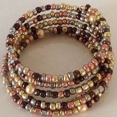 These are beautiful handmade  beaded bracelets which come in an assortment of widths.   Single strand to 8 strands.   Our single strand bracelets are great to wear with your other gold or silver bracelets to give them a touch of color to accent them. The price varies from $10.00 to $25.00. Please contact us for specific price or if you have any questions.  If you prefer a special color or style, we will take special orders. Multi-strand Beaded Bracelets With Spacer Beads As Gift, Multi-strand Bracelet With Gold Beads As Gift, Multi-strand Gold Beads Bracelet Gift, Elegant Multi-strand Bracelets With Colorful Beads, Gold Multi-strand Beaded Bracelet As Gift, Gold Hand-wrapped Beaded Bracelets, Multi-strand Bracelets With Colorful Beads For Jewelry Making, Beaded Multi-strand Wrap Bracelet, Gold Bohemian Wrap Bracelet With Spacer Beads