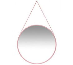 a round mirror hanging from a string on a white wall with a pink circle in the middle