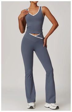 Expertly designed for maximum performance and comfort, the Aura Tank & Legging Set offers a V-front tank top with removable bra padding and V-front wide leg leggings. The two-tone design adds a touch of style while the absence of a front seam provides a smooth and seamless fit. Stay focused on your workout with this high-quality set. Product Details: Nylon/Spandex V-front tank top with removable bra padding V-front wide leg leggings Two-tone No Front Seam Imported Yoga Class Outfit, Twd Rick Grimes, Yoga Style Outfits, Crop Top Jumpsuit, Gym Sets, Wide Leg Leggings, Shopping Essentials, Ski Party, Pilates Clothes