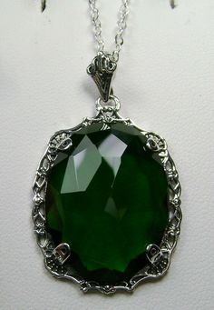 "Simulated Green Emerald Pendant Bubble Design#P10 Custom Made Inspired by Victorian era designs, I now offer this lovely Antique reproduction in sterling silver. The 22ct faceted simulated green emerald gemstone is 24mm long (15/16th\") and 18mm in width (3/4th\"). The entire pendant is 1.5\" long and 7/8\" wide. The chain (if chosen) is between 18-20 inches in length and is marked 925 as well. Notice the beautiful craftsmanship of the Victorian filigree setting. This pendant necklace is a true Emerald Brooch, Victorian Filigree, Pink Topaz Ring, Mystic Fire Topaz, Filigree Pendant Necklace, Bubble Design, Filigree Pendant, Emerald Pendant, Pink Topaz