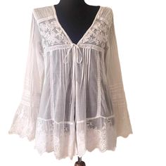 This Ibiza white women's top in size M features beautiful embroidered appliqué lace details, pleated motifs, V neckline and a tie front fastening. It's a stylish, bohemian blouse perfect for casual, wedding party or beach wear. Measurements /flat/ - shoulder to shoulder 16''/41cm armpit to armpit 17''/44cm waist 16.5''/42cm length 29''/74cm sleeves 24.5''/62cm Excellent condition. Summer Cotton Lace Blouse, Summer Cotton Lace Top Blouse, White Crochet Lace Top For Beach Cover-up, V-neck Lace Blouse With Floral Embroidery, Summer Long Sleeve Embroidered Lace Top, Long Sleeve Embroidered Lace Top For Summer, Embroidered Lace V-neck Top, Lace V-neck Blouse With Floral Embroidery, Summer Long Sleeve Lace Top With Floral Embroidery