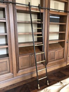 an empty room with wooden shelves and ladders