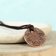 This simple yet stunning mandala necklace is the perfect piece to keep you centered. A mandala is a sacred space, often a circle, which reveals inner truth about you and the world around you. Speak, the universe is listening. ❤ 23mm Copper disc with mandala pattern ❤ 3mm Deer skin lace - choose your length To order yours, choose your options & add it to your cart. Choose your shipping method, and check out. Holistic Jewelry With Adjustable Cord For Meditation, Spiritual Necklace With Adjustable Cord, Adjustable Medallion Necklace For Healing, Spiritual Copper Necklace With Round Pendant, Copper Spiritual Necklace With Round Pendant, Adjustable Medallion Necklaces For Healing, Bohemian Bronze Medallion Necklace For Gift, Bohemian Medallion Jewelry For Meditation, Bohemian Bronze Medallion Necklace As Gift