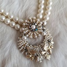 "This is a vintage statement necklace from the 1950's-1960's. The necklace is made from two white pearl tone bead strands. The pendant is also the clasp of the necklace and is a white pearl tone and AB crystal statement piece. The back is a gold tone metal with the Japan signature. The necklace has a few areas of wear on the back from age. The necklace is in great condition. Measurements: Strand Length: 17\" | Pendant Length: 2.25\" | Pendant Width: 1.75\" Unless otherwise stated all vintage ite Vintage Round Pearl Drop Jewelry, Vintage Round Pearl Drop Necklace, Vintage Pearl White Round Necklaces, Vintage White Round Beaded Necklaces, Vintage Round Necklace With Pearl Charm, Vintage Pearl Necklace With Round Beads, Vintage Pearl Necklace With Pendant, Vintage Pearl White Necklace With Pearl Pendant, Vintage Round Pearl Chain Necklace