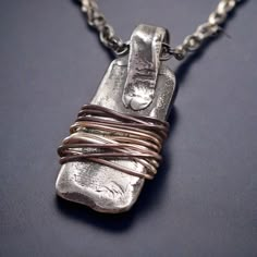 This handmade Amulet Warding Off pendant necklace is finely crafted from 925 sterling silver, with a dark patina finish, to create an eye-catching yet protective piece of jewelry. Flamed wire is wrapped around the amulet with a special process, to ward off any bad spirits or energy. This unique and unusual talisman makes the perfect gift to show your loved ones how much you care about them. Bad Spirits, Amulet Bracelet, Talisman Jewelry, Protection Amulet, Amulet Necklace, Unusual Jewelry, Patina Finish, Handmade Wire, Sterling Silver Necklace Pendants