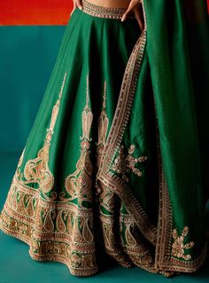 Dazzle in this dark green lehenga set, adorned with intricate embroidery highlighted by various embellishments. Paired elegantly with an embroidered dupatta, this ensemble is designed to make you stand out with its exquisite detailing and rich color, perfect for making a statement at special events. Designer Green Sharara With Intricate Embroidery, Festive Green Sharara With Intricate Embroidery, Green Anarkali Set With Dabka Work For Reception, Green Kundan Salwar Kameez With Intricate Embroidery, Green Sharara With Intricate Embroidery For Reception, Traditional Drape Dola Silk Lehenga With Dabka Work, Dola Silk Lehenga With Dabka Work In Traditional Drape, Traditional Drape Lehenga In Dola Silk With Dabka Work, Elegant Green Lehenga With Resham Embroidery