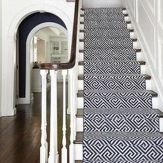 the stairs are decorated with black and white wallpaper