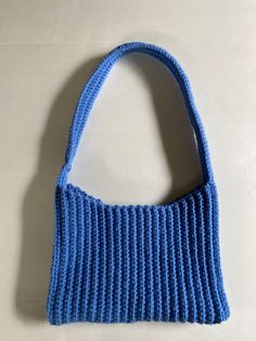 This is a blue crocheted shoulder bag. It is made using the single crochet stitch and will not stretch out over time. It is a perfect addition to any outfit. Cheap Handmade Blue Crochet Bag, Trendy Blue Crochet Tote Bag, Trendy Blue Crochet Bags, Trendy Blue Crochet Bag For Everyday Use, Trendy Blue Crochet Bag For Everyday, Blue Crochet Shoulder Bag For Everyday, Blue Knitted Shoulder Bag For Daily Use, Casual Blue Crochet Bag For Everyday Use, Blue Knitted Shoulder Bag For Everyday