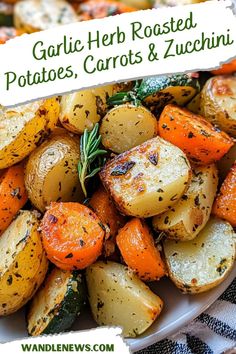 garlic herb roasted potatoes, carrots and zucchini in a white bowl on a table