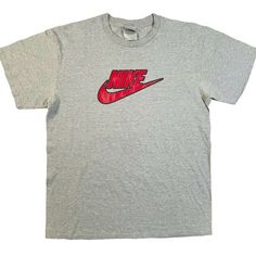 Vintage early 2000s Nike tee, gray with black and red swoosh and spell out on front center of chest.  Men's large, please see measurements below. 28" length 20" width Gray Y2k Style Summer T-shirt, Athletic Heather Logo Print Top For Streetwear, Athletic Heather Sporty T-shirt For Streetwear, Gray Y2k Style T-shirt For Streetwear, Athletic Heather T-shirt With Letter Print For Streetwear, Vintage Nike Shirt, Sporty Heather Grey T-shirt For Streetwear, Y2k Gray T-shirt For Streetwear, Gray Streetwear T-shirt For Sports Season