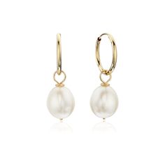 These beautiful large gold pearl drop hoop earrings are a classy addition to any outfit, especially a wedding dress! Made purely with 9ct gold and a large freshwater pearl, our pearl drop earrings are the perfect jewellery gift for a bride! Our pearl earrings are handmade in our London studio. To keep your jewellery shining bright, we recommend giving it a little care over time. By using a soft, lint-free jewellery cloth, you can remove blemishes that result from body oils, perfumes and lotions, whilst protecting the finish on your beautiful Lily & Roo jewellery from future damage.  TOP TIPS Avoid the five S's - Sleep, Shower, Swim, Sprays (perfumes) & Sweat (exercise).  Always ensure you fasten up your necklaces and store each piece individually in a cool, dry and dark place, to help prev Handmade Hoop Earrings, Drop Hoop Earrings, Pearl Jewelry Wedding, A Wedding Dress, Freshwater Pearls Earrings, Large Hoop Earrings, Jewellery Gift, Diamond Fashion, Earrings Collection