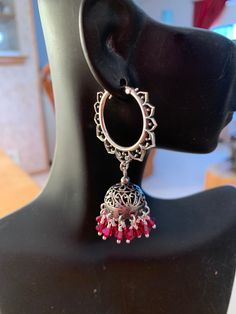 A very Ornate Pair of Sterling Silver Jhumkas are paired with Ruby Red Swarovski Crystals, these dangle from very  ornate Lotus Shaped( Kamala or Padma) hoops.  The pairing of jhumkas with hoops give these an exotic look. The ruby red crystals are very romantic and are great for the hot summer ahead. These are famous in Jaipur, Rajasthan and all over India. Pair this with any outfit you can dream of, you'll love these. My only pair don't miss out on these...  Total length is 2". Metal - Sterling Silver Jhumkas, Jaipur Rajasthan, Red Crystals, Ruby Red, Jaipur, Jewelry Earrings Dangle, Swarovski Crystals, Lotus, Dangle Drop Earrings