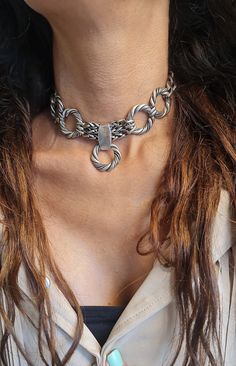 ◾ A beautiful and striking choker necklace made of silver-plated brass.    The necklace is adorned with round, twisted hoops, a foxtail chain, and a curb chain, making it suitable     For both evening and morning events. ◾   SIZE Length: 11.8IN (30cm) up to 16.5IN (42cm)       Width Hoop:  0.98IN(2.5cm).      Width curb: 0.39IN (1cm) thick chain: 0.19IN (5mm)      In addition to the length of the chain, there is an extension chain of 2.36IN (6cm) ◾   You can see a similar choker at this link:  ◾  NEW!  oxidized Chain bold necklace, Large circle Hoop necklace, Statement Chunky Necklace, large      Unique Choker collar, Edgy O ring Choker ◾  The shipment is in the registered mail including a tracking number.  ◾  This piece of jewelry is perfect as a gift for yourself, for a wedding day, Vale Thick Choker, Edgy Rings, Unique Choker, Chunky Silver Necklace, Hoop Necklace, O Ring Choker, Chain Collar, Silver Choker Necklace, Chain Making