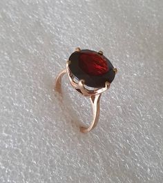 Garnet and gold ring.  Huge roung Garnet set in 10 carat pink/rose gold. Round Garnet ring. AAA quality genuine Garnet weighs 6.6 carats and measures 12 mm in diameter. The 10 carat setting is in the form of a crown and is in rose gold. Ring size is K (Australian size) or 5 1/8 (US size). Ring is ready to ship in 1-2 working days.  We resize free of charge.  Please allow a couple of additional days for resizing. This ring can be custom made to your specification.  Contact us with your queries. Large Garnet Ring, Pink Garnet, Black Opal Ring, Green Amethyst Ring, Garnet And Gold, Women's Rings, Garnet Ring, White Gold Band, Garnet Rings