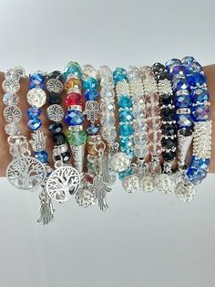 This are assorted charm bracelets made using  a stretching thread, beads and charms. The bracelets are marked with numbers for one to choose their preferred one in the next photo. The bracelets have a stretch thread hence can fit comfortable on any hand size. Shipping remains constant no matter the quantity of bracelets purchased.  Shipping is fast and only takes 3-7 days to ship worldwide Friendship Hand Wrapped Bangle Bracelet, Bohemian Crystal Bracelet With Faceted Beads As Gift, Round Charm Bracelet With Faceted Beads, Round Charm Bracelet With Faceted Beads For Gift, Spiritual Charm Bracelet With Faceted Beads As A Gift, Assorted Adjustable Spiritual Jewelry, Bohemian Friendship Bracelets With Charms, Bohemian Assorted Bracelets, Bohemian Style Assorted Color Bracelet Jewelry