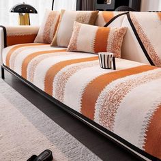 an orange and white striped couch in a living room